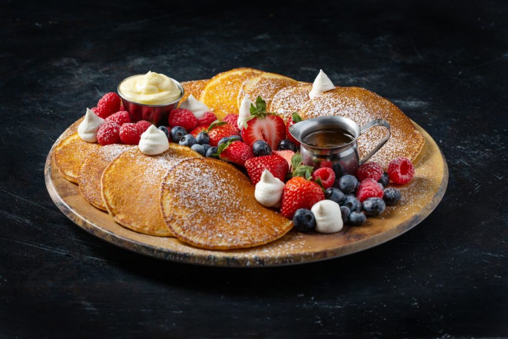 A plate of pancakes with berries from Flanker Kitchen + Sporting Club.